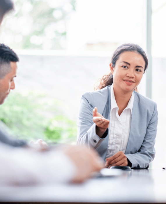 woman-pointing-hand-in-a-meeting